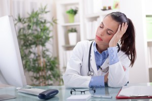 young doctor in a stressful situation has a headache